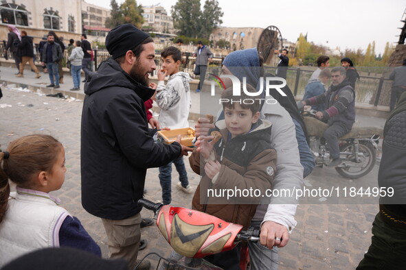 Celebrations continue in the city of Hama, where Syrians gather at Al-Assi Square to take commemorative photos and express their joy over th...