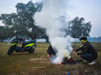 People burn fires, causing smoke on a winter morning in Kolkata, India, on December 8, 2024. (