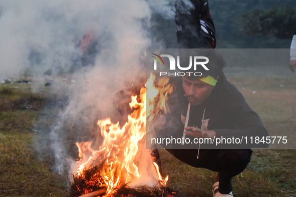 People burn fires, causing smoke on a winter morning in Kolkata, India, on December 8, 2024. 