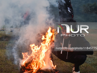 People burn fires, causing smoke on a winter morning in Kolkata, India, on December 8, 2024. (