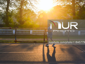 A person runs on the street on an early winter morning in Kolkata, India, on December 8, 2024. (