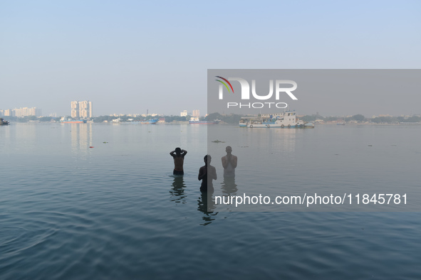 People bathe in the river Ganges on an early winter morning in Kolkata, India, on December 8, 2024. 