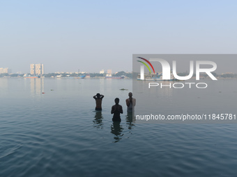 People bathe in the river Ganges on an early winter morning in Kolkata, India, on December 8, 2024. (