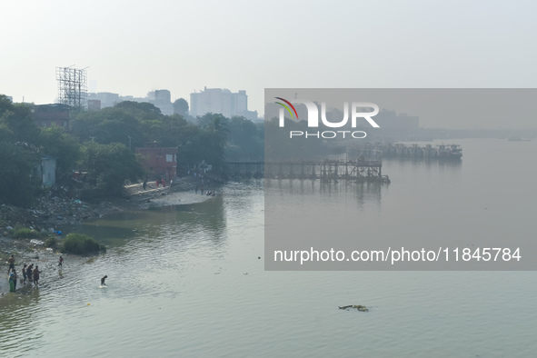 People bathe in the river Ganges on an early winter morning in Kolkata, India, on December 8, 2024. 