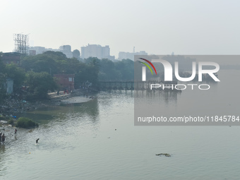 People bathe in the river Ganges on an early winter morning in Kolkata, India, on December 8, 2024. (