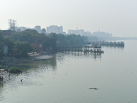 People bathe in the river Ganges on an early winter morning in Kolkata, India, on December 8, 2024. (