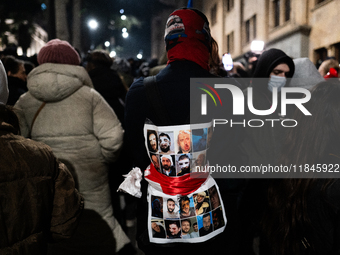 Anti-government protesters hold pictures of fellow demonstrators injured in alleged police beatings as they rally for a tenth consecutive da...