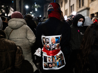 Anti-government protesters hold pictures of fellow demonstrators injured in alleged police beatings as they rally for a tenth consecutive da...