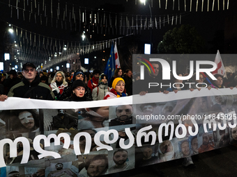 Anti-government protesters stage a march in support of detained fellow activists during a tenth consecutive day of mass demonstrations again...