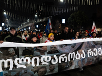 Anti-government protesters stage a march in support of detained fellow activists during a tenth consecutive day of mass demonstrations again...