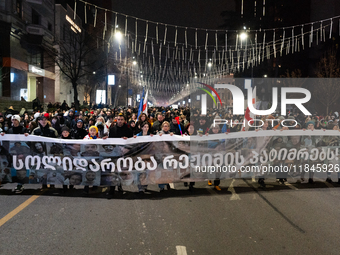 Anti-government protesters stage a march in support of detained fellow activists during a tenth consecutive day of mass demonstrations again...