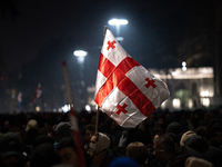 Anti-government protesters carry EU and Georgian flags as they rally for a tenth consecutive day of mass demonstrations against the governme...