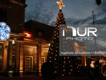 A large, illuminated Christmas tree stands on the esplanade of the Tlalpan City Hall for the December holidays in the Center of Tlalpan, in...