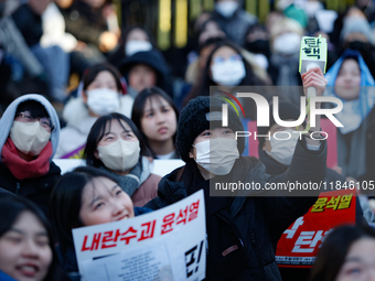 Tens of thousands of citizens gather across from the National Assembly in Yeouido, Seoul, South Korea, on December 8, 2024, holding signs th...