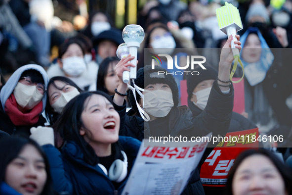 Tens of thousands of citizens gather across from the National Assembly in Yeouido, Seoul, South Korea, on December 8, 2024, holding signs th...