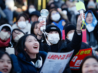 Tens of thousands of citizens gather across from the National Assembly in Yeouido, Seoul, South Korea, on December 8, 2024, holding signs th...