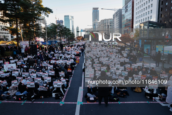 Tens of thousands of citizens gather across from the National Assembly in Yeouido, Seoul, South Korea, on December 8, 2024, holding signs th...