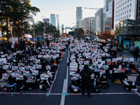 Tens of thousands of citizens gather across from the National Assembly in Yeouido, Seoul, South Korea, on December 8, 2024, holding signs th...