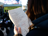 A student participates in a protest in Seoul, South Korea, on December 8, 2024, across from the National Assembly, studying for next week's...