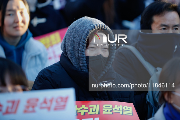 Thousands of citizens gather across from the National Assembly in Yeouido, in Seoul, South Korea, on December 8, 2024, holding signs that re...