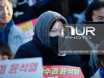 Thousands of citizens gather across from the National Assembly in Yeouido, in Seoul, South Korea, on December 8, 2024, holding signs that re...