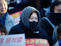 Thousands of citizens gather across from the National Assembly in Yeouido, in Seoul, South Korea, on December 8, 2024, holding signs that re...