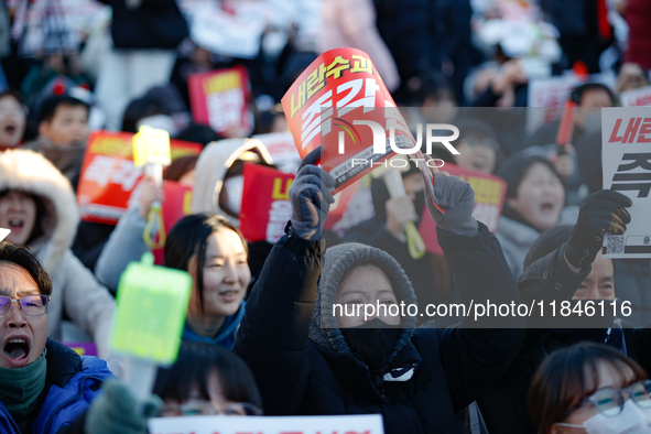 Thousands of citizens gather across from the National Assembly in Yeouido, in Seoul, South Korea, on December 8, 2024, holding signs that re...