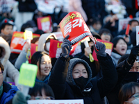 Thousands of citizens gather across from the National Assembly in Yeouido, in Seoul, South Korea, on December 8, 2024, holding signs that re...