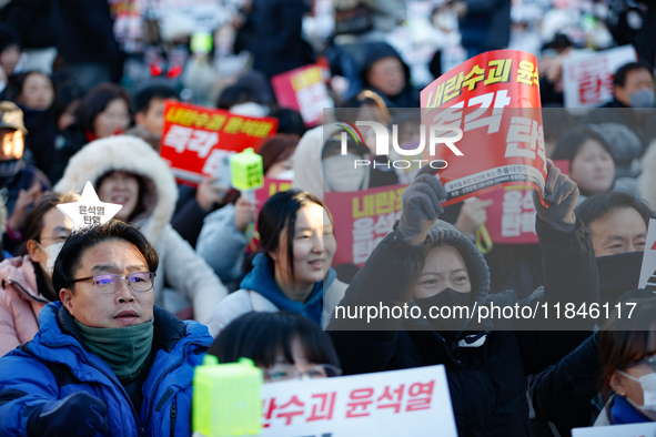 Thousands of citizens gather across from the National Assembly in Yeouido, in Seoul, South Korea, on December 8, 2024, holding signs that re...