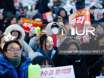 Thousands of citizens gather across from the National Assembly in Yeouido, in Seoul, South Korea, on December 8, 2024, holding signs that re...