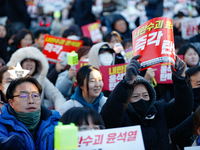 Thousands of citizens gather across from the National Assembly in Yeouido, in Seoul, South Korea, on December 8, 2024, holding signs that re...