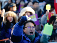 A man protests in Yeouido, Seoul, South Korea, on December 8, 2024, across from the National Assembly, holding a sign that reads, ''Impeach...