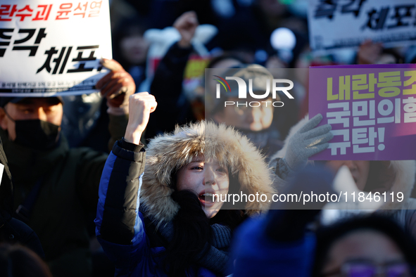 Thousands of citizens gather across from the National Assembly in Yeouido, in Seoul, South Korea, on December 8, 2024, holding signs that re...