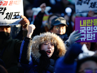 Thousands of citizens gather across from the National Assembly in Yeouido, in Seoul, South Korea, on December 8, 2024, holding signs that re...