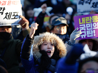 Thousands of citizens gather across from the National Assembly in Yeouido, in Seoul, South Korea, on December 8, 2024, holding signs that re...