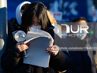 A student participates in a protest in Seoul, South Korea, on December 8, 2024, across from the National Assembly, studying for next week's...