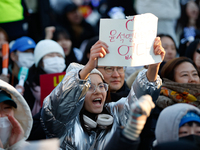 A student protests in Yeouido, Seoul, South Korea, on December 8, 2024, across from the National Assembly, holding a sign that reads, ''Pres...