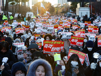 Tens of thousands of citizens gather across from the National Assembly in Yeouido, Seoul, South Korea, on December 8, 2024, holding signs th...