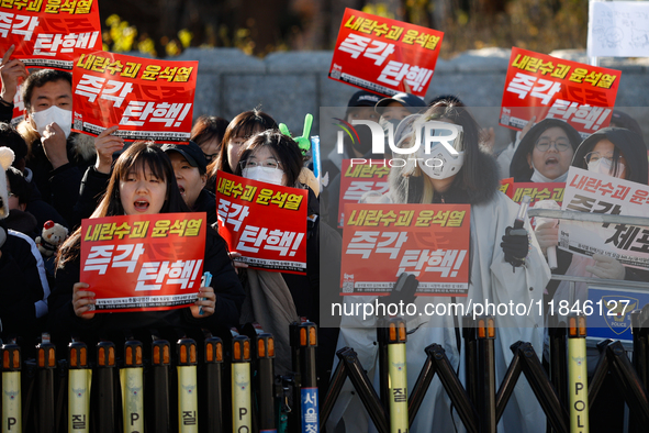 Tens of thousands of citizens gather across from the National Assembly in Yeouido, Seoul, South Korea, on December 8, 2024, holding signs th...