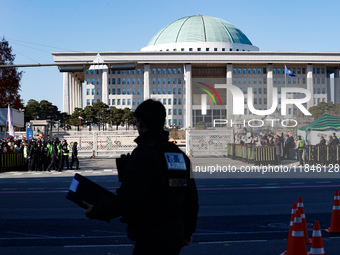 Tens of thousands of citizens gather across from the National Assembly in Yeouido, Seoul, South Korea, on December 8, 2024, holding signs th...