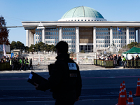 Tens of thousands of citizens gather across from the National Assembly in Yeouido, Seoul, South Korea, on December 8, 2024, holding signs th...