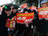 Tens of thousands of citizens gather across from the National Assembly in Yeouido, Seoul, South Korea, on December 8, 2024, holding signs th...