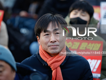 Han Chang-min, leader and National Assembly member of the Social Democratic Party, joins a candlelight protest in Seoul, South Korea, on Dec...