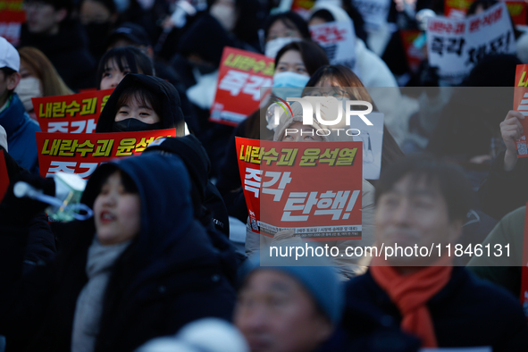 Thousands of citizens gather across from the National Assembly in Yeouido, in Seoul, South Korea, on December 8, 2024, holding signs that re...