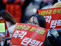 Tens of thousands of citizens gather across from the National Assembly in Yeouido, Seoul, South Korea, on December 8, 2024, holding signs th...