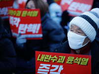 Tens of thousands of citizens gather across from the National Assembly in Yeouido, Seoul, South Korea, on December 8, 2024, holding signs th...