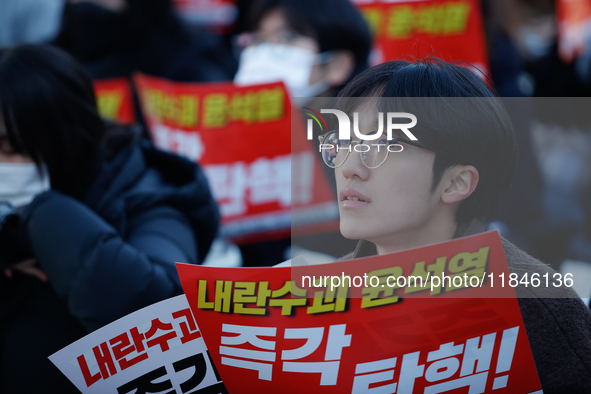 Tens of thousands of citizens gather across from the National Assembly in Yeouido, Seoul, South Korea, on December 8, 2024, holding signs th...