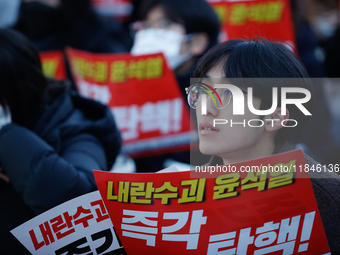 Tens of thousands of citizens gather across from the National Assembly in Yeouido, Seoul, South Korea, on December 8, 2024, holding signs th...