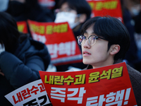 Tens of thousands of citizens gather across from the National Assembly in Yeouido, Seoul, South Korea, on December 8, 2024, holding signs th...