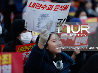 Tens of thousands of citizens gather across from the National Assembly in Yeouido, Seoul, South Korea, on December 8, 2024, holding signs th...